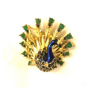 Goldtone peacock pin.